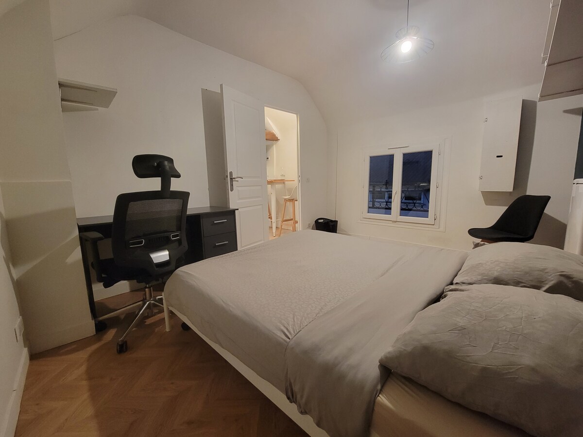 Chambres — Deux lits, bureau noir, ambiance minimaliste, lumière douce
